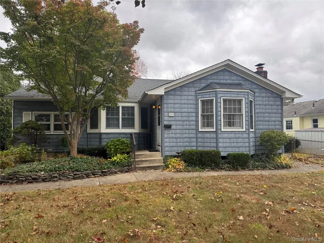 a view of a brick house next to a yard