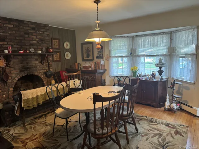 a dining room with furniture a chandelier and window