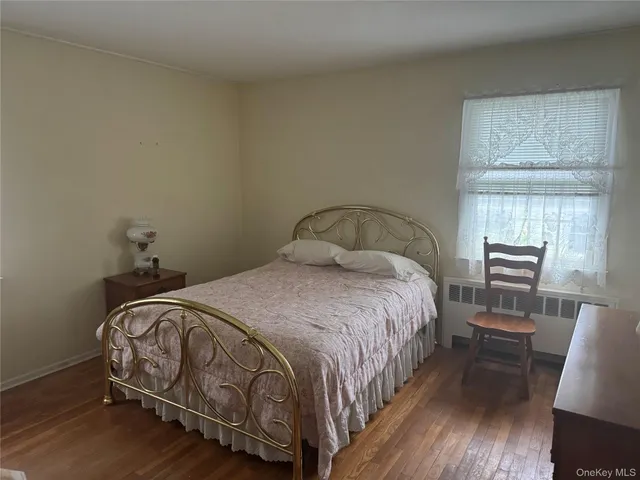a bedroom with a bed and a chair