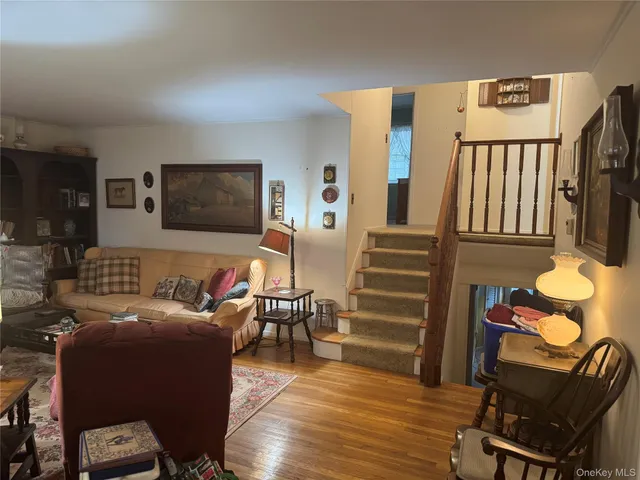 a backyard of a house with large trees and wooden fence