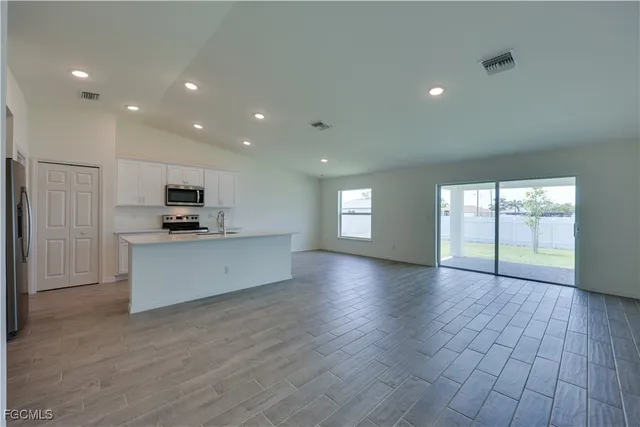 a view of kitchen with cabinets and wooden floor