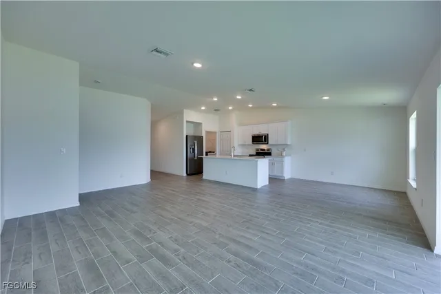 a view of kitchen with a sink wooden floor and kitchen view
