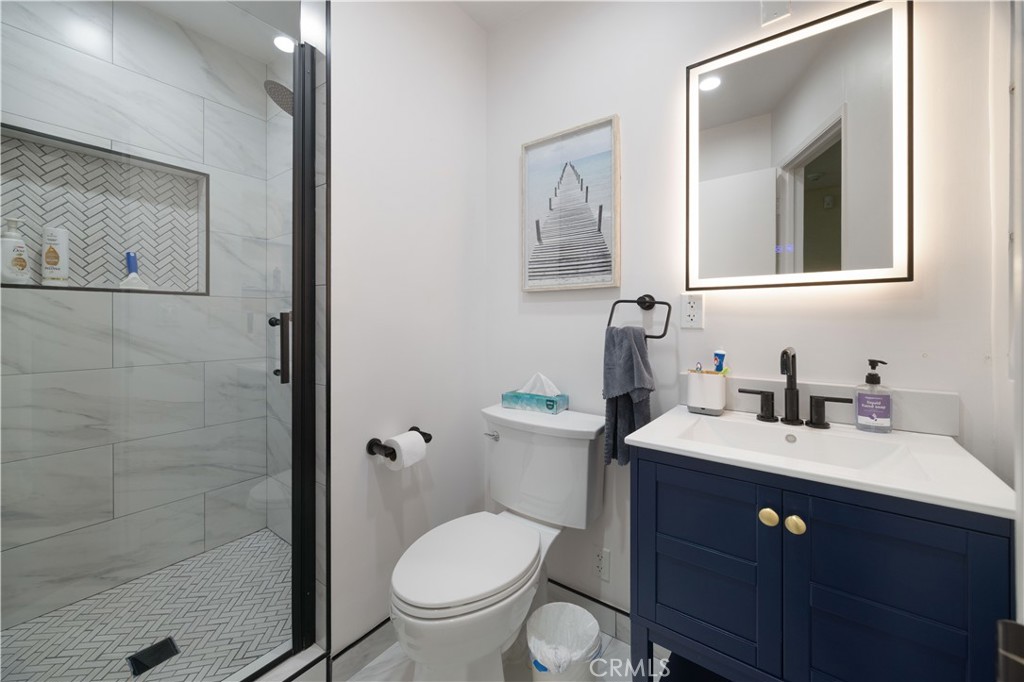 2518 Curtis Avenue, Unit 3 Redondo Beach, CA 90278 - Photo 20 of 35 a bathroom with a granite countertop toilet sink and mirror