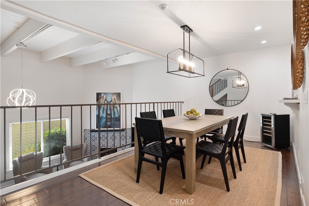 2518 Curtis Avenue, Unit 3 Redondo Beach, CA 90278 - Photo 6 of 35 a view of a dining room and livingroom with furniture wooden floor a rug a fireplace and a chandelier