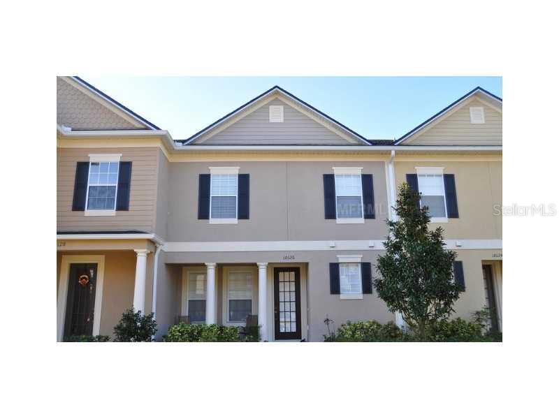 10126 Ridgebloom Avenue Orlando, FL 32829 - Photo 1 of 1 a front view of a house with a garden