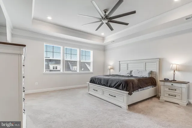 a spacious bedroom with a large bed and a window