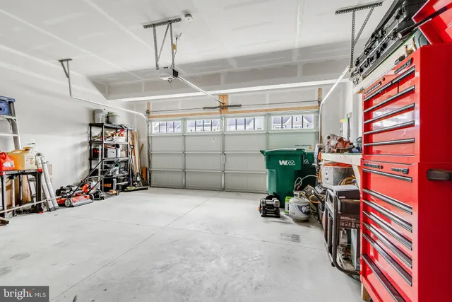 a front view of a building with a yard and a garage
