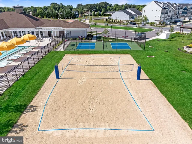 an aerial view of a swimming pool with a table and chairs