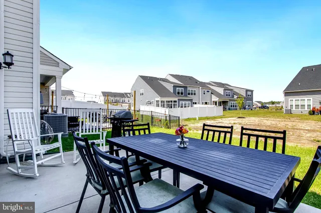 a view of a roof deck with table and chairs