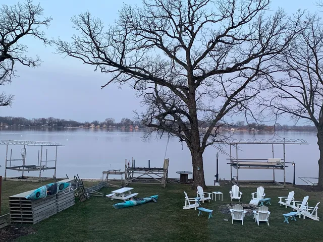 a backyard of a house with table and chairs