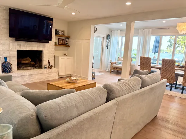 a living room with furniture fireplace and flat screen tv