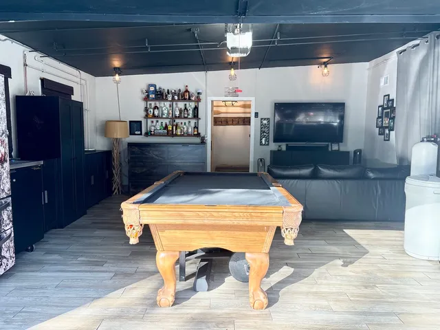 a kitchen with a wooden floor and refrigerator