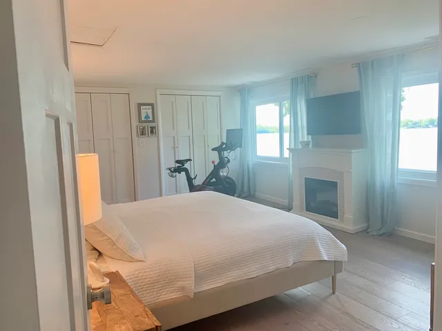 a bedroom with a bed and a fireplace