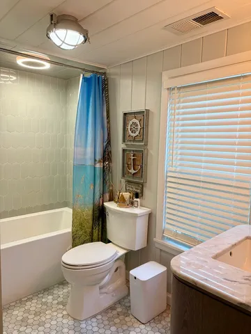 a bathroom with a toilet a sink and bathtub
