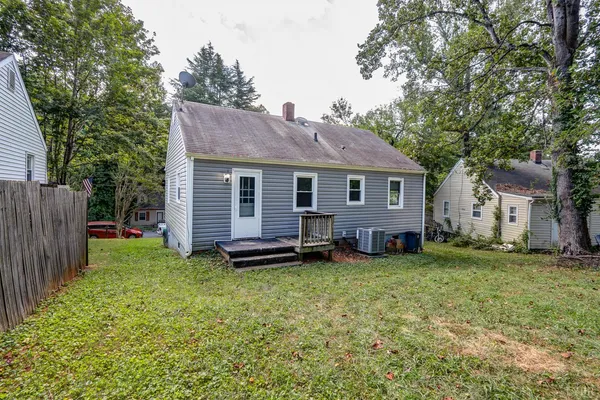 a view of a house with a yard and sitting area