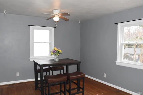 a dining room with window a chandelier