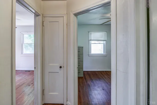 a view of a hallway with wooden floor
