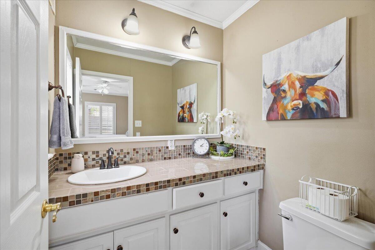 2702 20th Street Lubbock, TX 79410 - Photo 20 of 34 a bathroom with a sink and a mirror