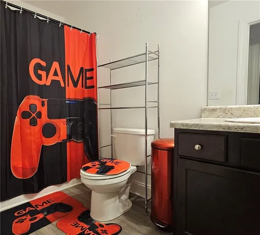 a bathroom with a sink toilet and mirror