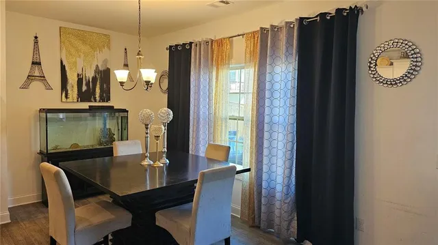 a dining room with furniture and wooden floor