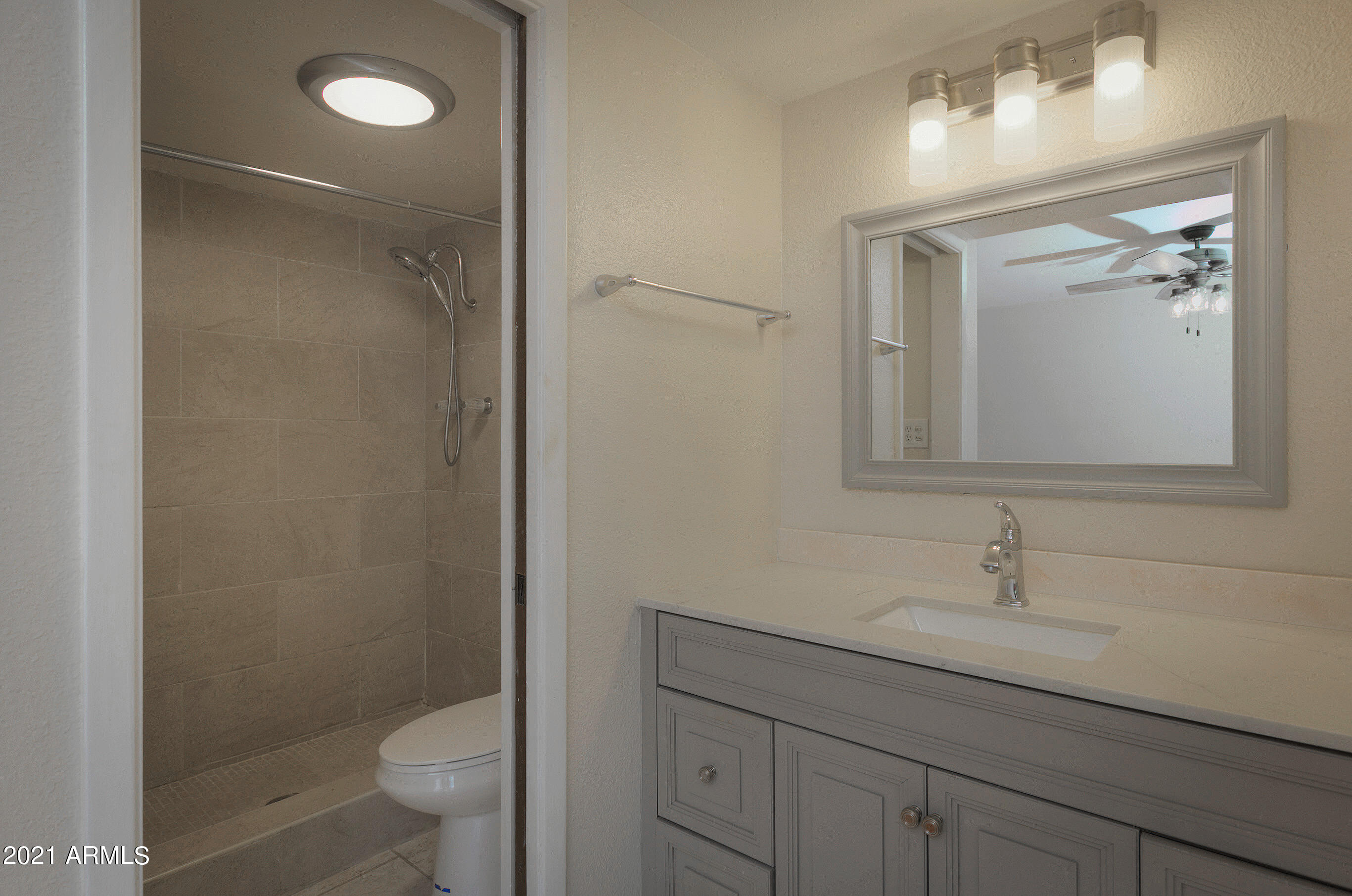 926 North Date Mesa, AZ 85201 - Photo 18 of 24 a bathroom with a toilet a sink and mirror