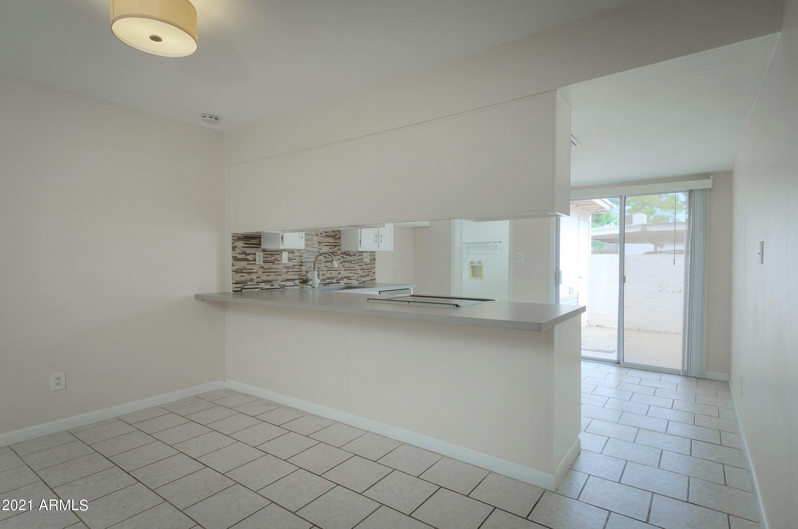 926 North Date Mesa, AZ 85201 - Photo 7 of 24 a kitchen with white cabinets and a sink