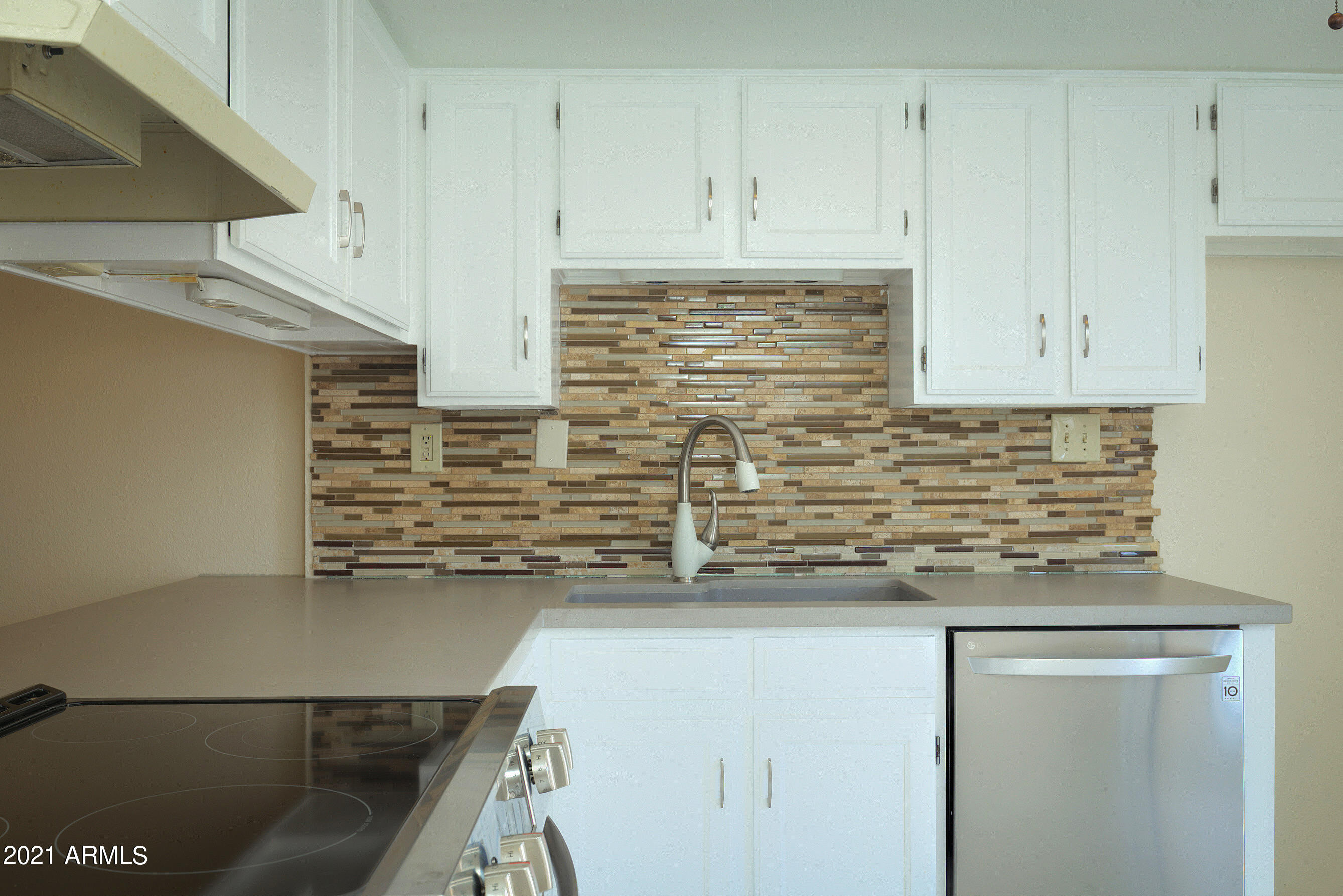 926 North Date Mesa, AZ 85201 - Photo 8 of 24 a kitchen with granite countertop white cabinets and stainless steel appliances