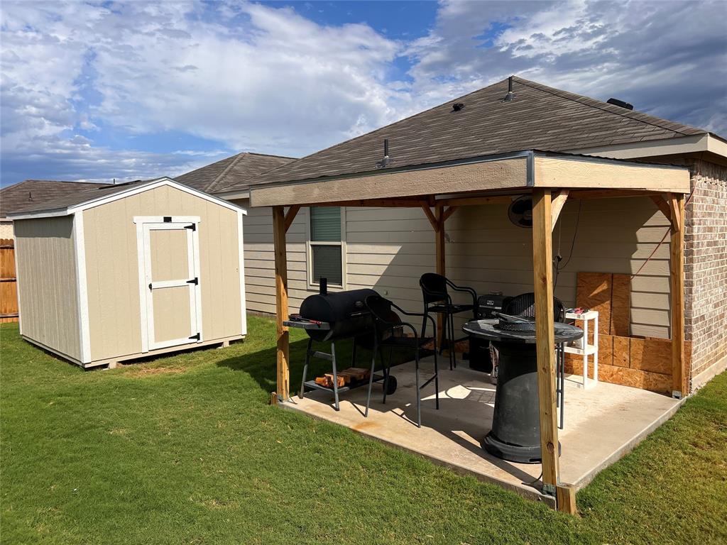 14941 Trapper Trail Haslet, TX 76052 - Photo 19 of 22 a patio with table and chairs and potted plants