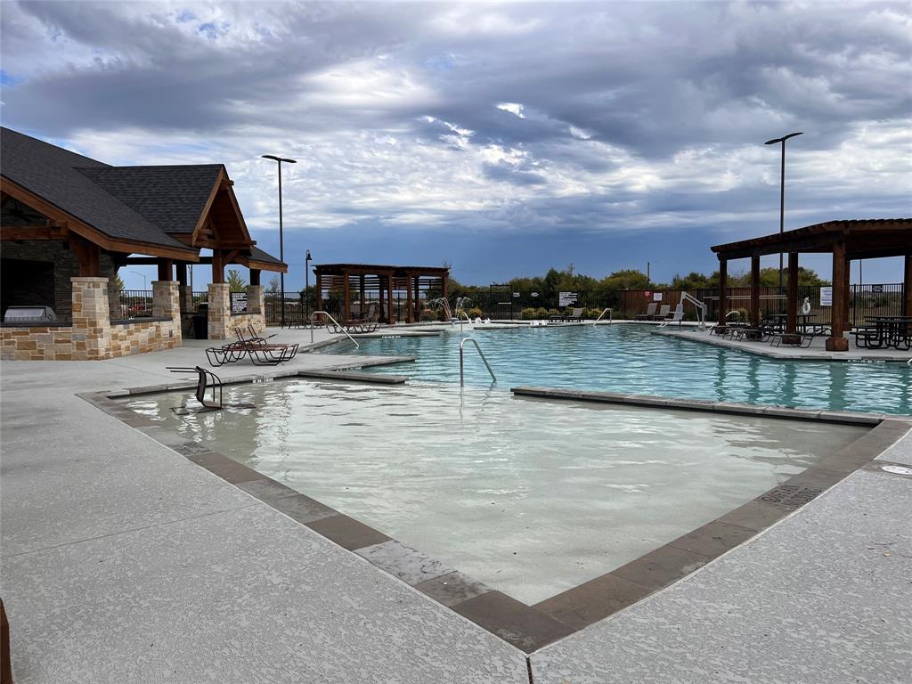 14941 Trapper Trail Haslet, TX 76052 - Photo 4 of 22 a view of a swimming pool with a terrace