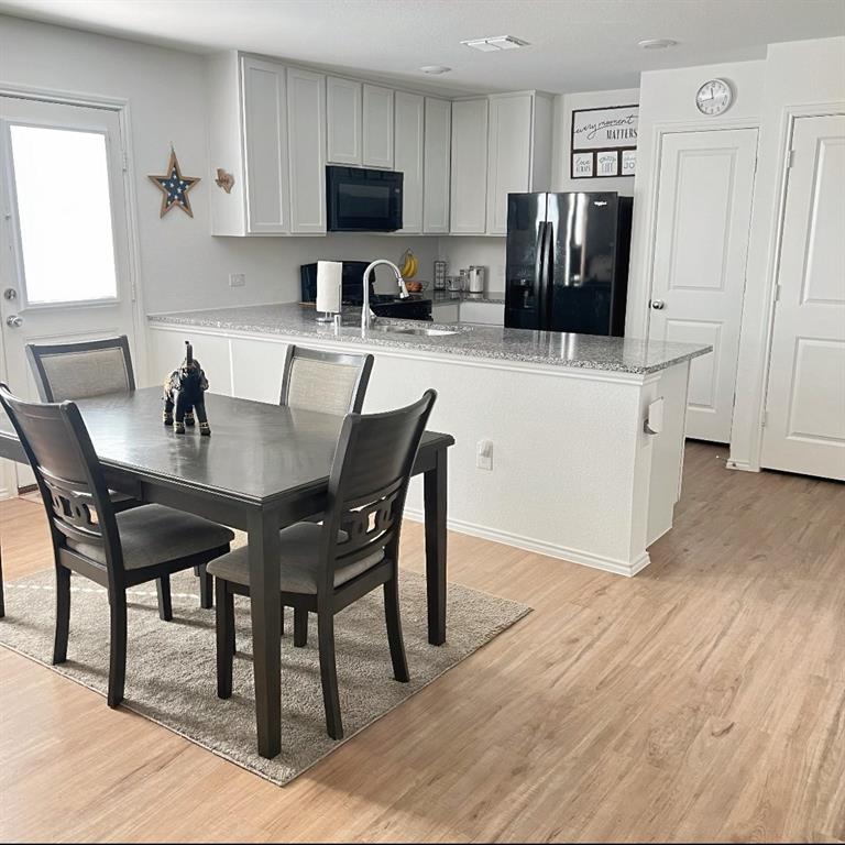 14941 Trapper Trail Haslet, TX 76052 - Photo 5 of 22 a kitchen with stainless steel appliances refrigerator dining table and chairs