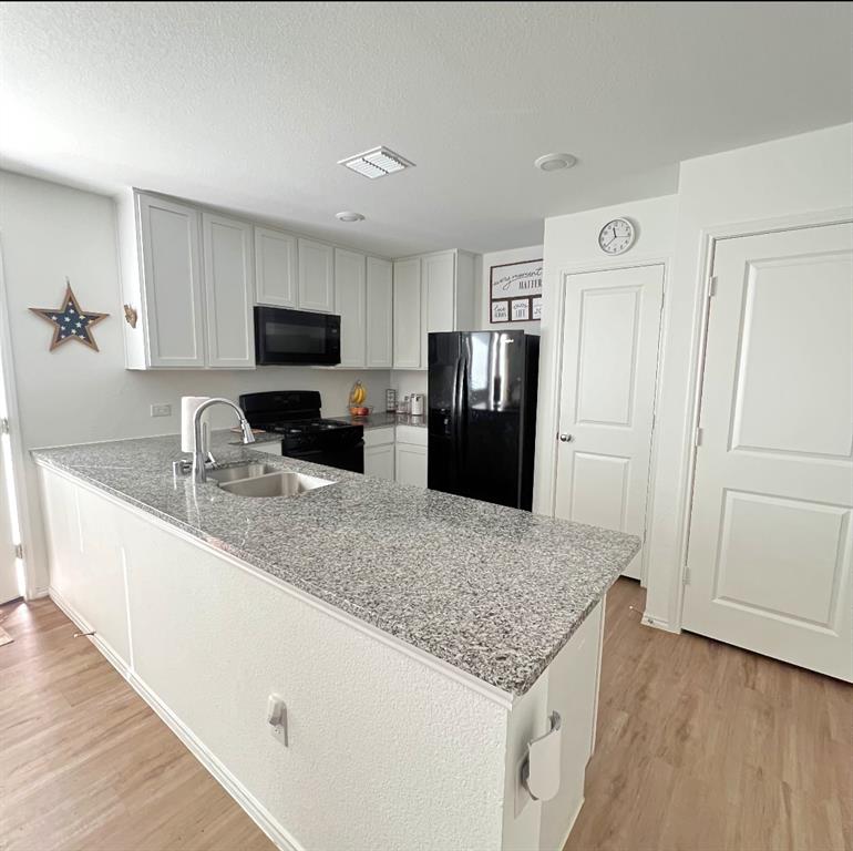 14941 Trapper Trail Haslet, TX 76052 - Photo 7 of 22 a kitchen with granite countertop a refrigerator stove and sink