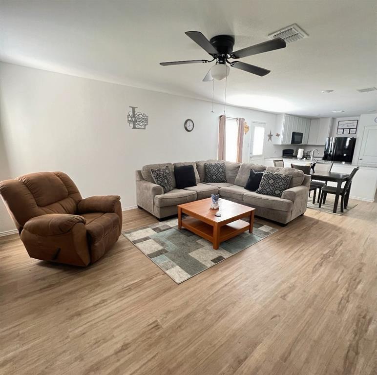 14941 Trapper Trail Haslet, TX 76052 - Photo 9 of 22 a living room with furniture ceiling fan and a rug