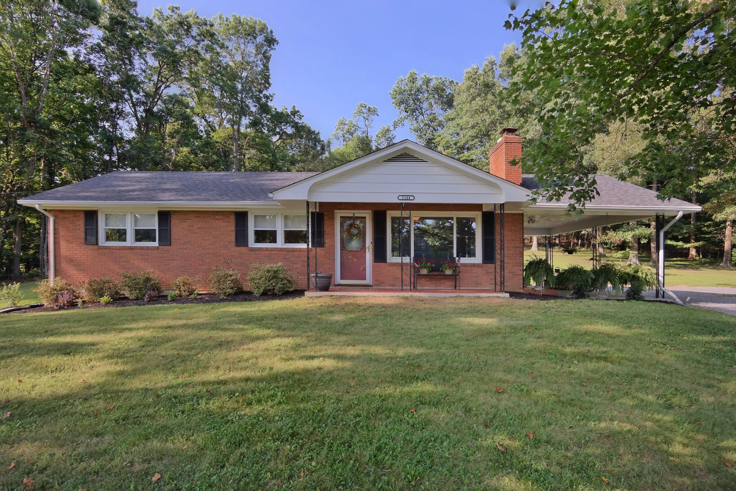 2144 Blue Ridge Springs Road Blue Ridge, VA 24064 - Photo 1 of 35 a front view of a house with a garden