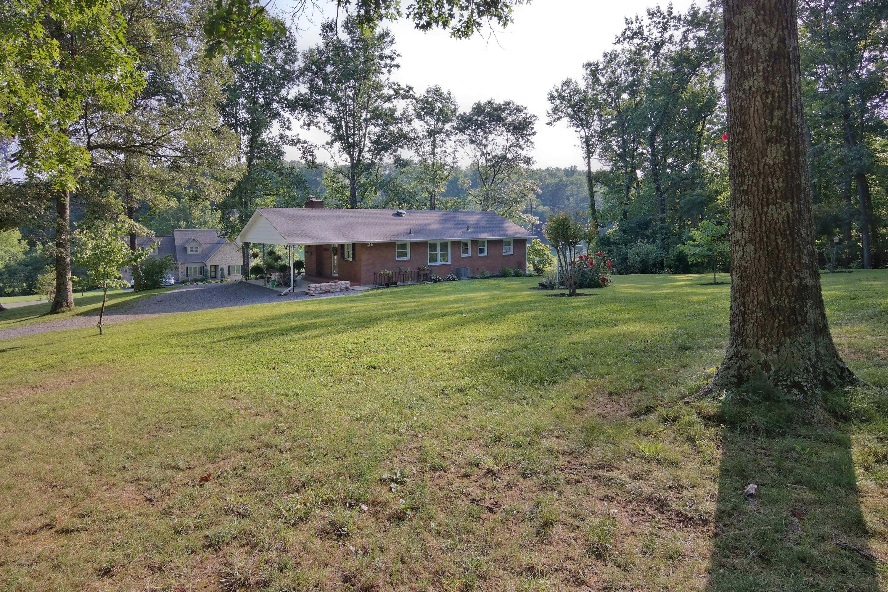 2144 Blue Ridge Springs Road Blue Ridge, VA 24064 - Photo 12 of 35 a view of a big yard with plants and large trees