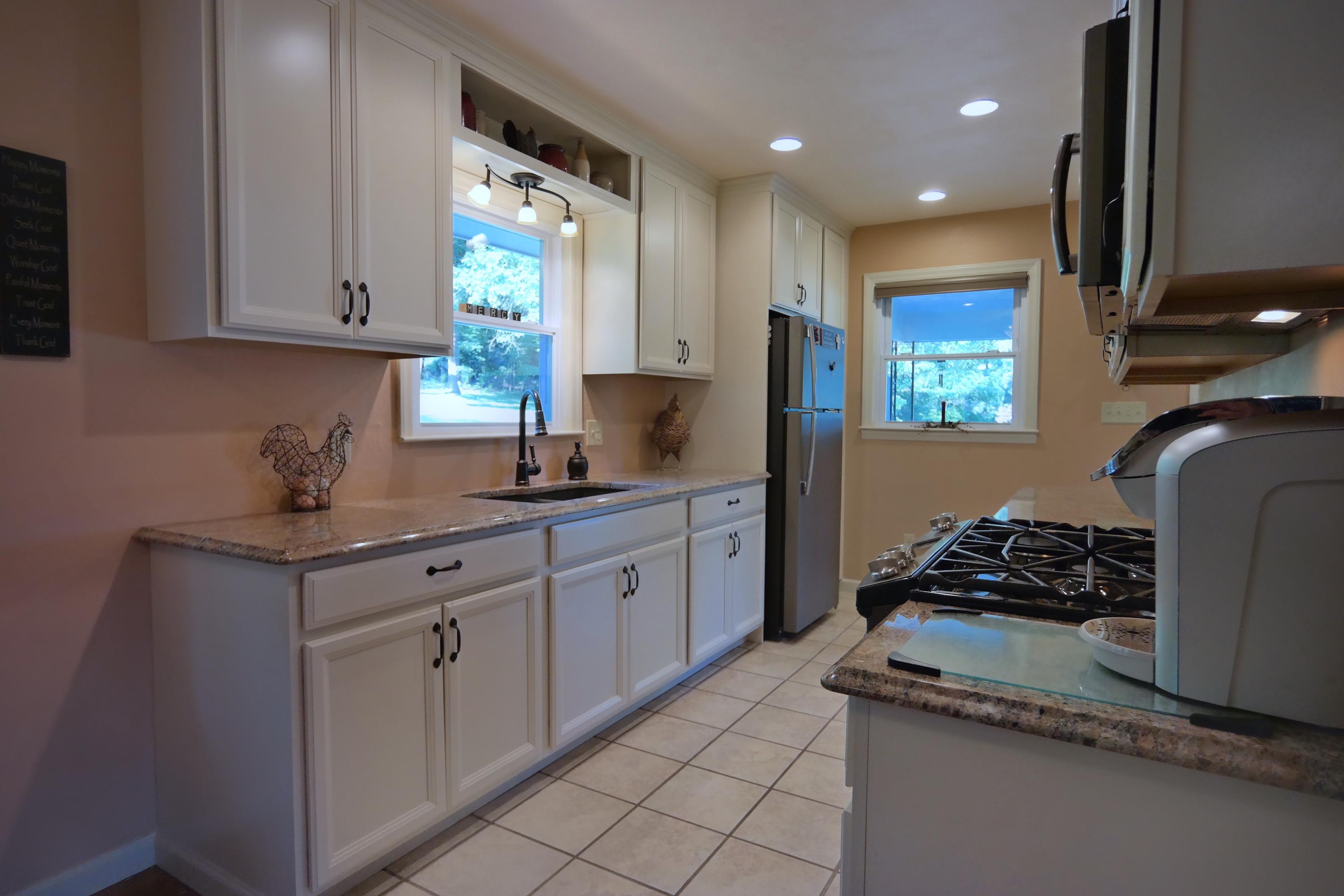 2144 Blue Ridge Springs Road Blue Ridge, VA 24064 - Photo 15 of 35 a kitchen with white cabinets and window