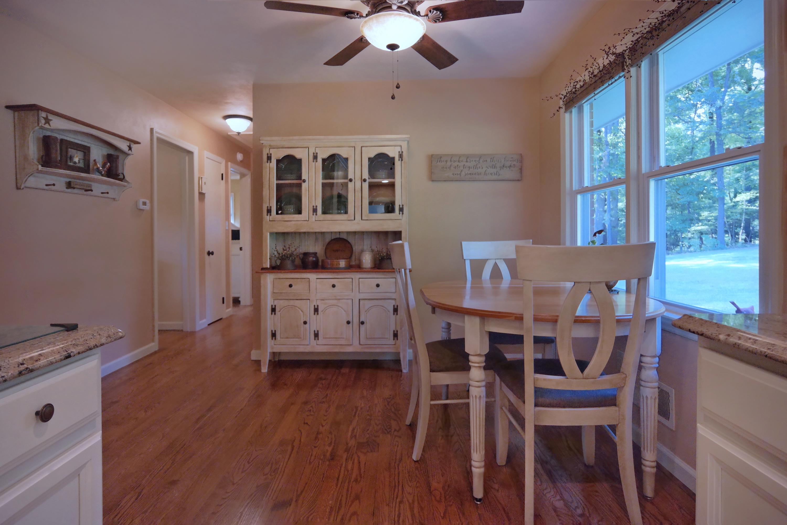 2144 Blue Ridge Springs Road Blue Ridge, VA 24064 - Photo 19 of 35 a view of a dining room with furniture and wooden floor