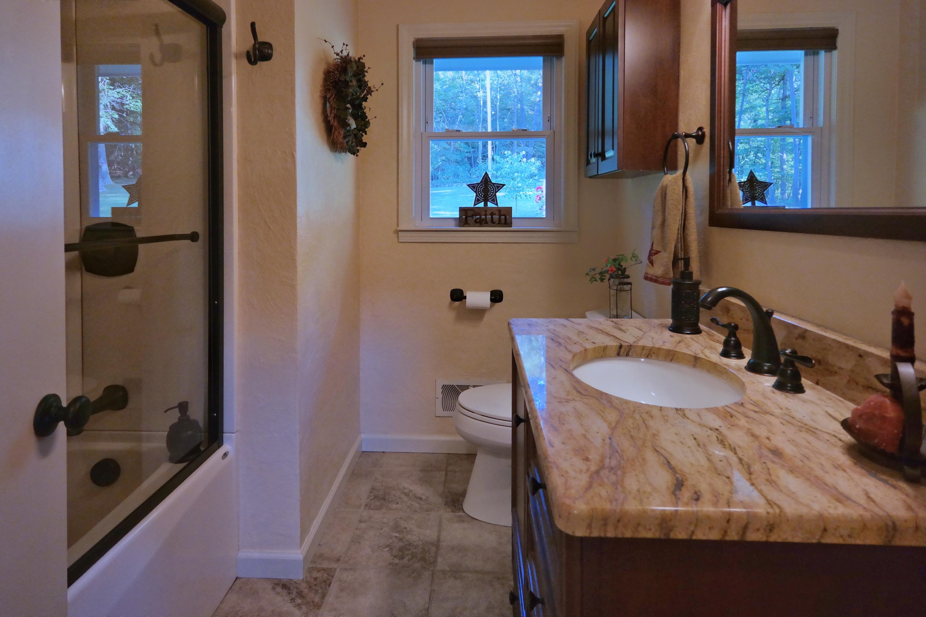 2144 Blue Ridge Springs Road Blue Ridge, VA 24064 - Photo 24 of 35 a bathroom with a tub sink and mirror