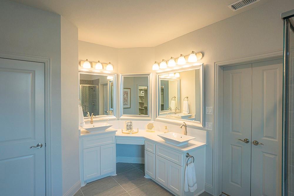 330 Aeronca Drive Fate, TX 75087 - Photo 12 of 32 a bathroom with a tub sink and mirror