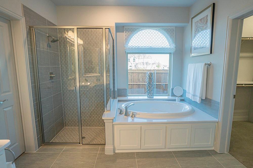 330 Aeronca Drive Fate, TX 75087 - Photo 13 of 32 a bathroom with a tub shower and sink