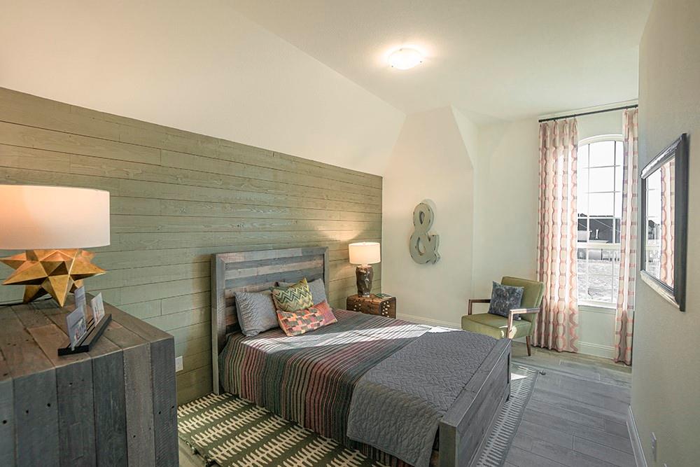 330 Aeronca Drive Fate, TX 75087 - Photo 15 of 32 a bedroom with a bed and wooden floor