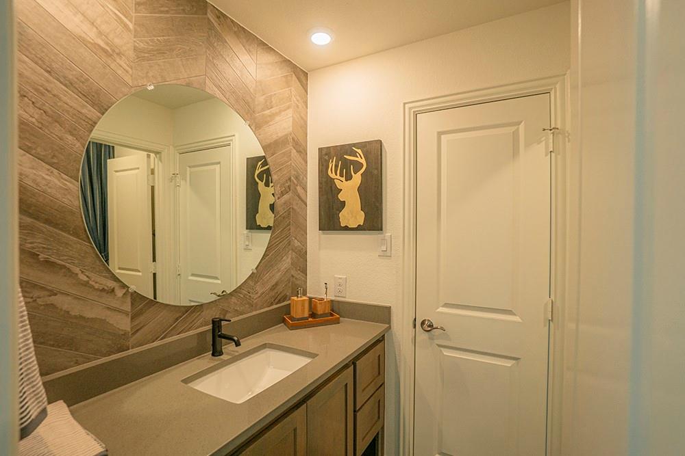 330 Aeronca Drive Fate, TX 75087 - Photo 16 of 32 a bathroom with a sink and a mirror