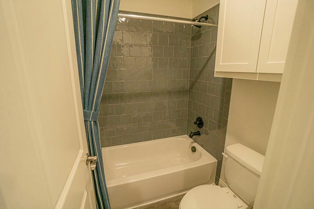 330 Aeronca Drive Fate, TX 75087 - Photo 17 of 32 a bathroom with a shower and a white bath tub