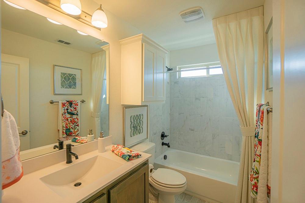 330 Aeronca Drive Fate, TX 75087 - Photo 19 of 32 a bathroom with a sink a toilet and shower