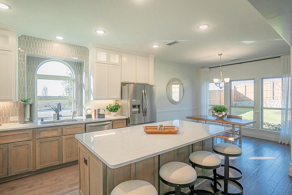 330 Aeronca Drive Fate, TX 75087 - Photo 7 of 32 a large kitchen with a table and chairs