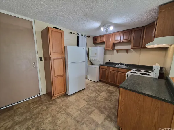 a kitchen with stainless steel appliances granite countertop a refrigerator a stove a sink dishwasher and a refrigerator