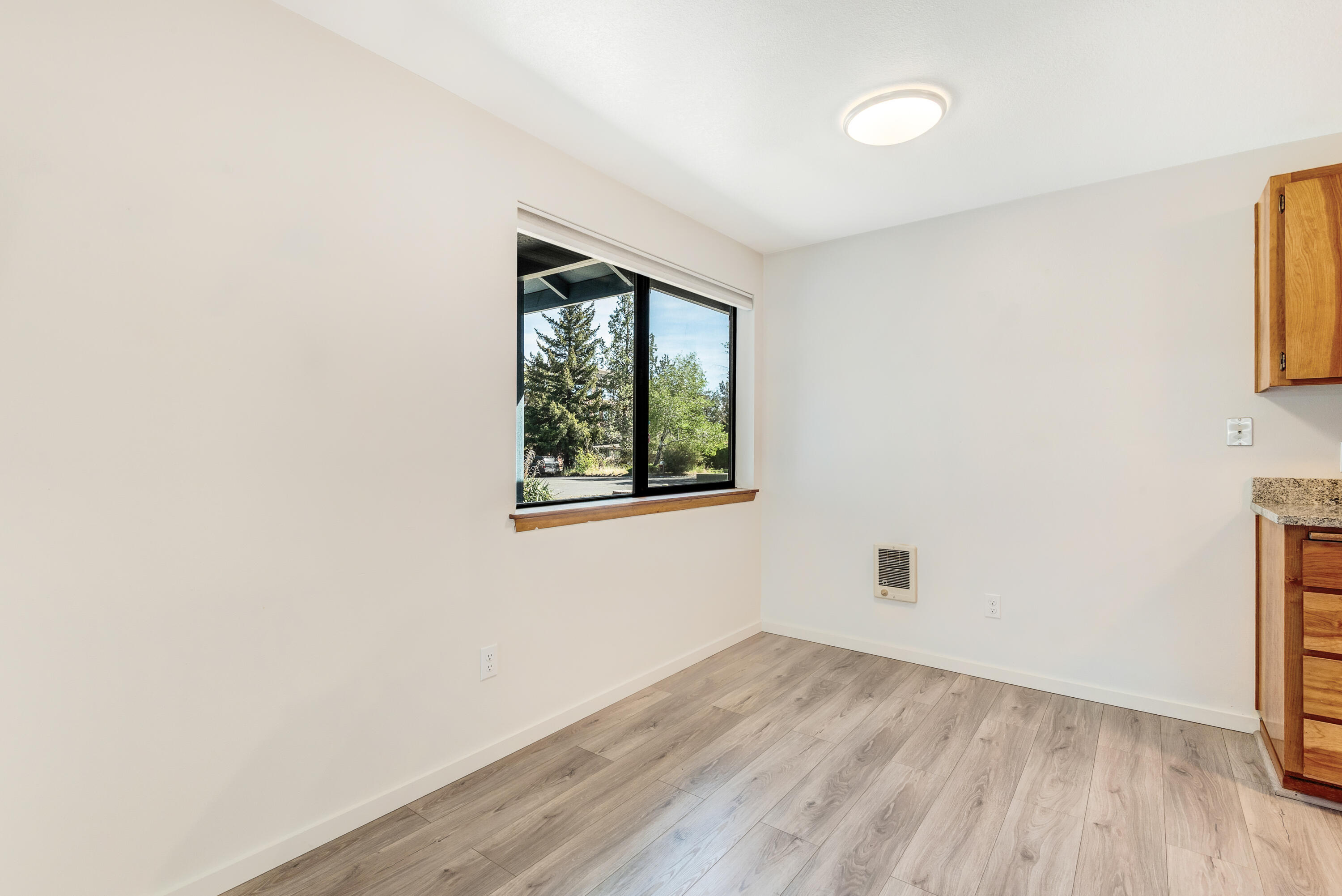 1916 Northeast Wichita Way Bend, OR 97701 - Photo 9 of 38 an empty room with wooden floor and windows
