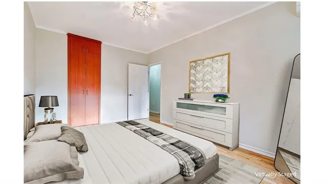 a bedroom with a bed and a chandelier