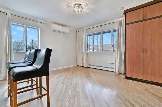 a view of workspace room with wooden floor and windows