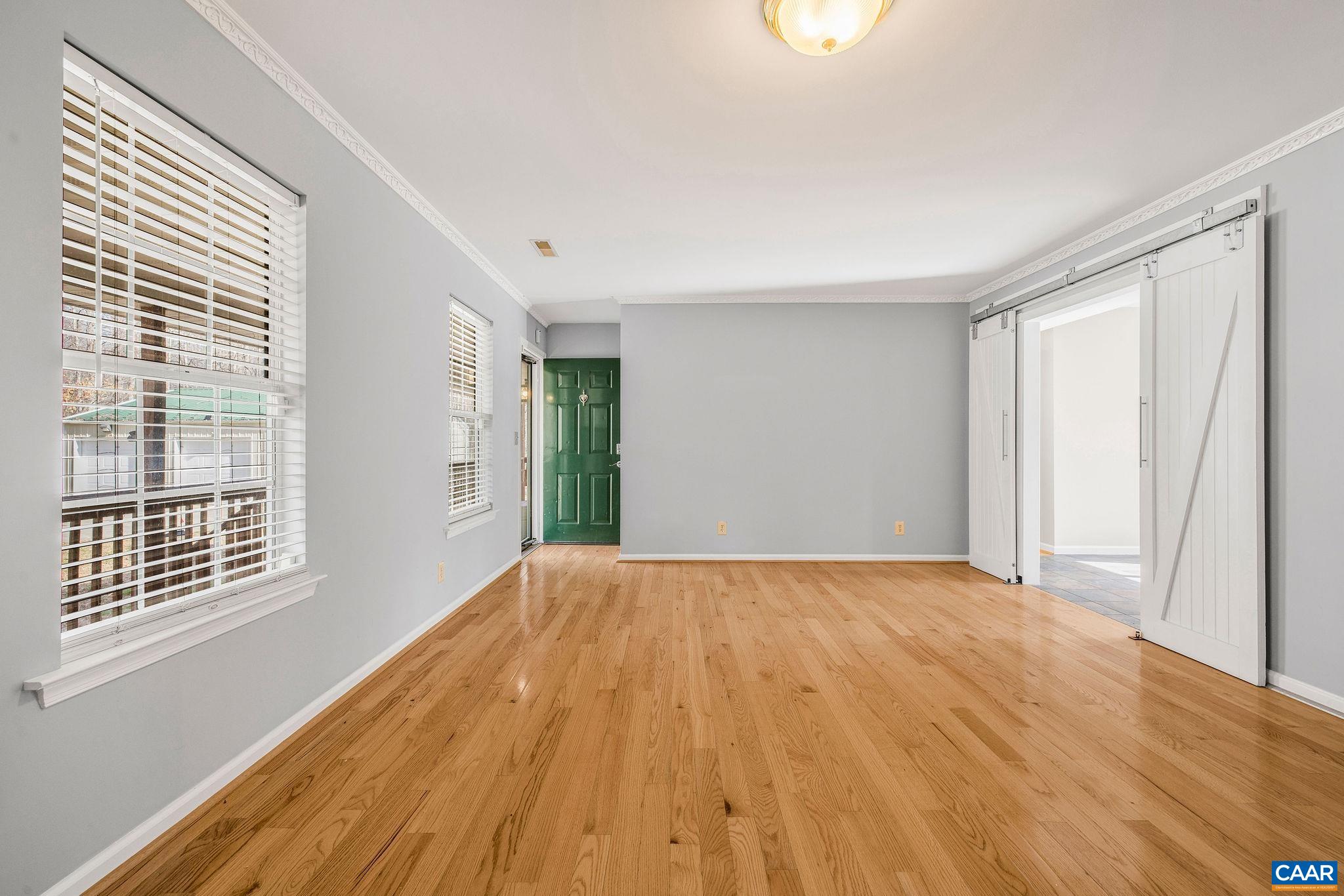462 Fox Hunters Lane Madison, VA 22727 - Photo 12 of 65 a view of an empty room with wooden floor and a window
