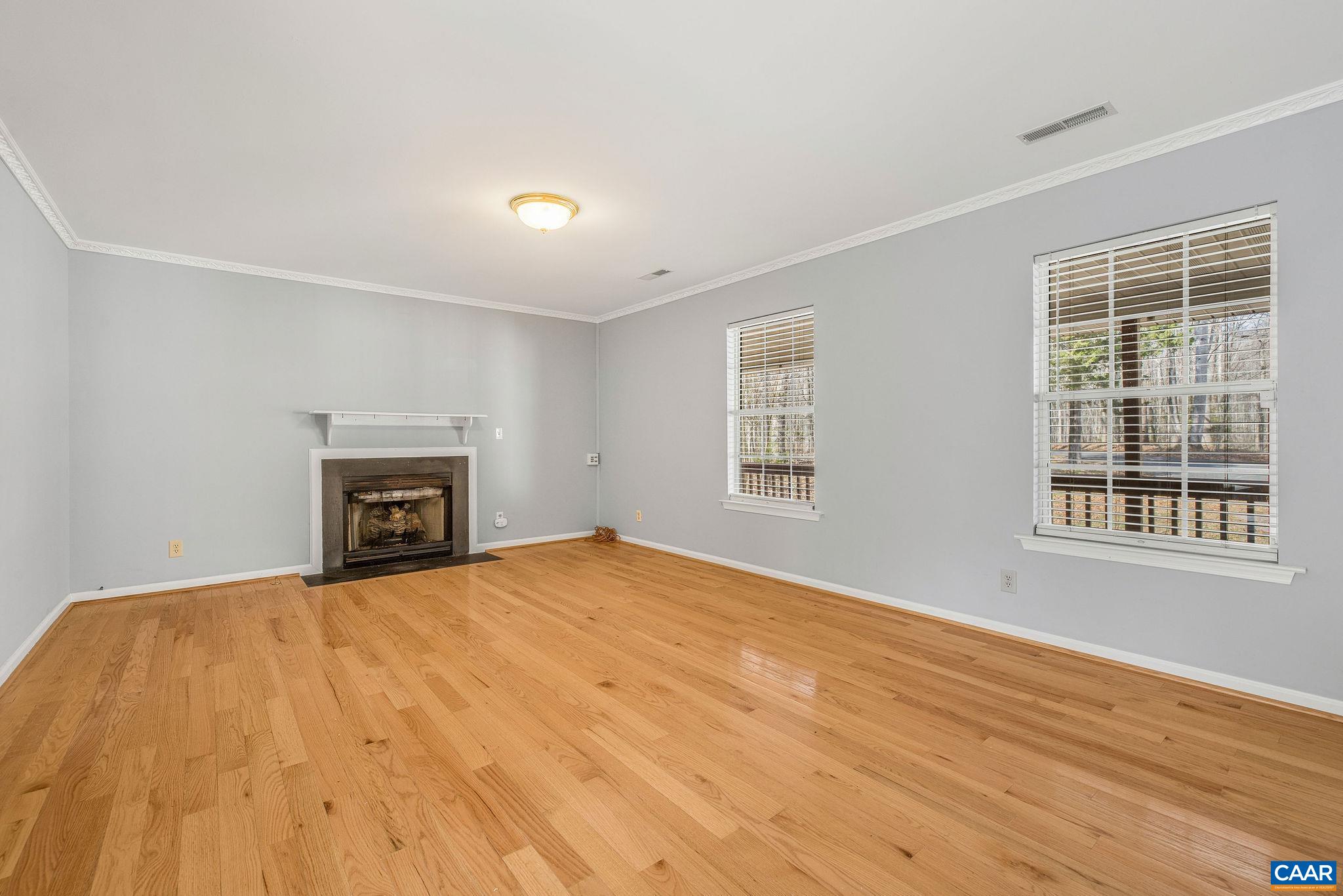 462 Fox Hunters Lane Madison, VA 22727 - Photo 14 of 65 a view of empty room with wooden floor and fireplace